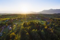 Germany, Upper Bavaria, Alpine Foreland, Aerial view of Seehausen at sunrise — Stock Photo