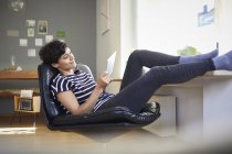Relaxed woman using tablet at home — Stock Photo