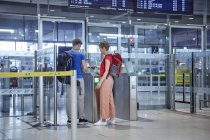 Casal passagem portão de segurança no aeroporto — Fotografia de Stock