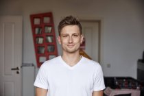 Portrait of smiling young man at home — Stock Photo