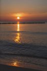 Germany, Mecklenburg-Western Pomerania, Wustrow, Baltic Sea, breakwater at sunset in winter — Stock Photo