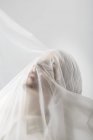 Graceful woman trapped in a veil — Stock Photo