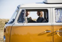 Couple on a road trip in their camper, looking at map — Stock Photo