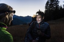 Couple hiking at night, wearing head lamps — Stock Photo
