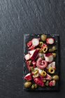 Octopus salad on black slate slab — Stock Photo