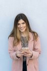 Ritratto di una giovane donna felice con il cellulare in mano — Foto stock