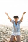 Thailand, woman using virtual reality glasses on the beach in the morning light — Stock Photo