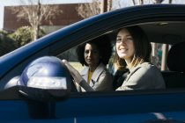 Retrato de duas mulheres dirigindo em um carro — Fotografia de Stock