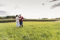 Senior couple dancing in rural landscape — Stock Photo