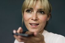 Portrait of a blond businesswoman, using smartphone — Stock Photo