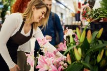 Verkäuferin berät Paar im Blumenladen — Stockfoto