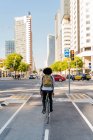 Rear view of casual businessman on bicycle in the city, Barcelona, Spain — Stock Photo