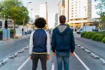 Rear view of two men standing on the street in the city, Barcelona, Spain — Stock Photo