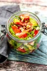 Strawberry avocado salad with feta, rocket and pine nuts in jar — Stock Photo