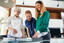 Couple shopping for a new kitchen in showroom looking at papers — Stock Photo