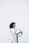 Little girl wearing space suit in front of white background looking around — Stock Photo