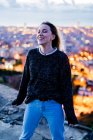 Happy young woman at dawn above the city, Barcelona, Spain — Stock Photo
