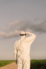 Rear view of man wearing protective suit in the countryside — Stock Photo
