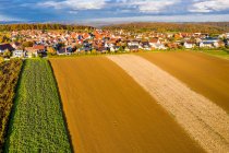 Germany, Baden Wurttemberg, Rems-Murr-Kreis, Aerial view of village and fields in Autumn — Stock Photo