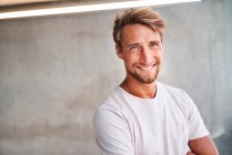 Portrait of smiling young man wearing white t-shirt — Stock Photo