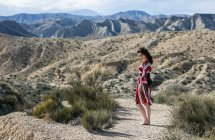 Fashionable woman wearing striped dress in landscape, Almeria, Spain — Stock Photo