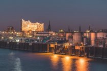 Germany, Hamburg, Kleiner Grasbrook harbor at dusk with Elbphilharmonie hall in background — Stock Photo
