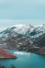 View to snow-covered mountains and lake, Leon Province, Spain — Stock Photo