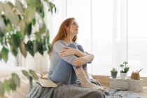 Serious young woman at home looking up — Stock Photo