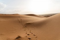 Footprints in sand dunes in Sahara Desert, Merzouga, Morocco — Stock Photo
