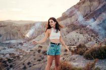 Portrait of smiling young woman with sparkler at sunset, Almeria, Spain — Stock Photo