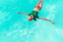 Mujer flotando en el agua en la piscina - foto de stock