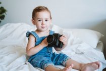 Ragazza che tiene la fotocamera a casa — Foto stock
