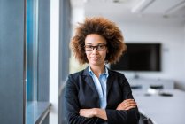 Portrait of confident young businesswoman in conference room — Stock Photo