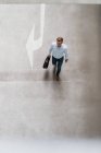 High angle view of businessman with bag walking in city — Stock Photo
