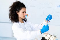 Жіночий дослідник експериментує з хімічним розчином у пекарні. — стокове фото