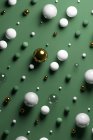 Gold, glass, marble spheres against pastel green background — Stock Photo