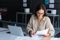 Smiling businesswoman working at office — Stock Photo