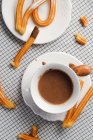 Cup of hot chocolate and fresh churros — Stock Photo
