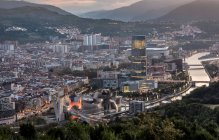 Spain, Biscay, Bilbao, Riverside city at dusk — Stock Photo