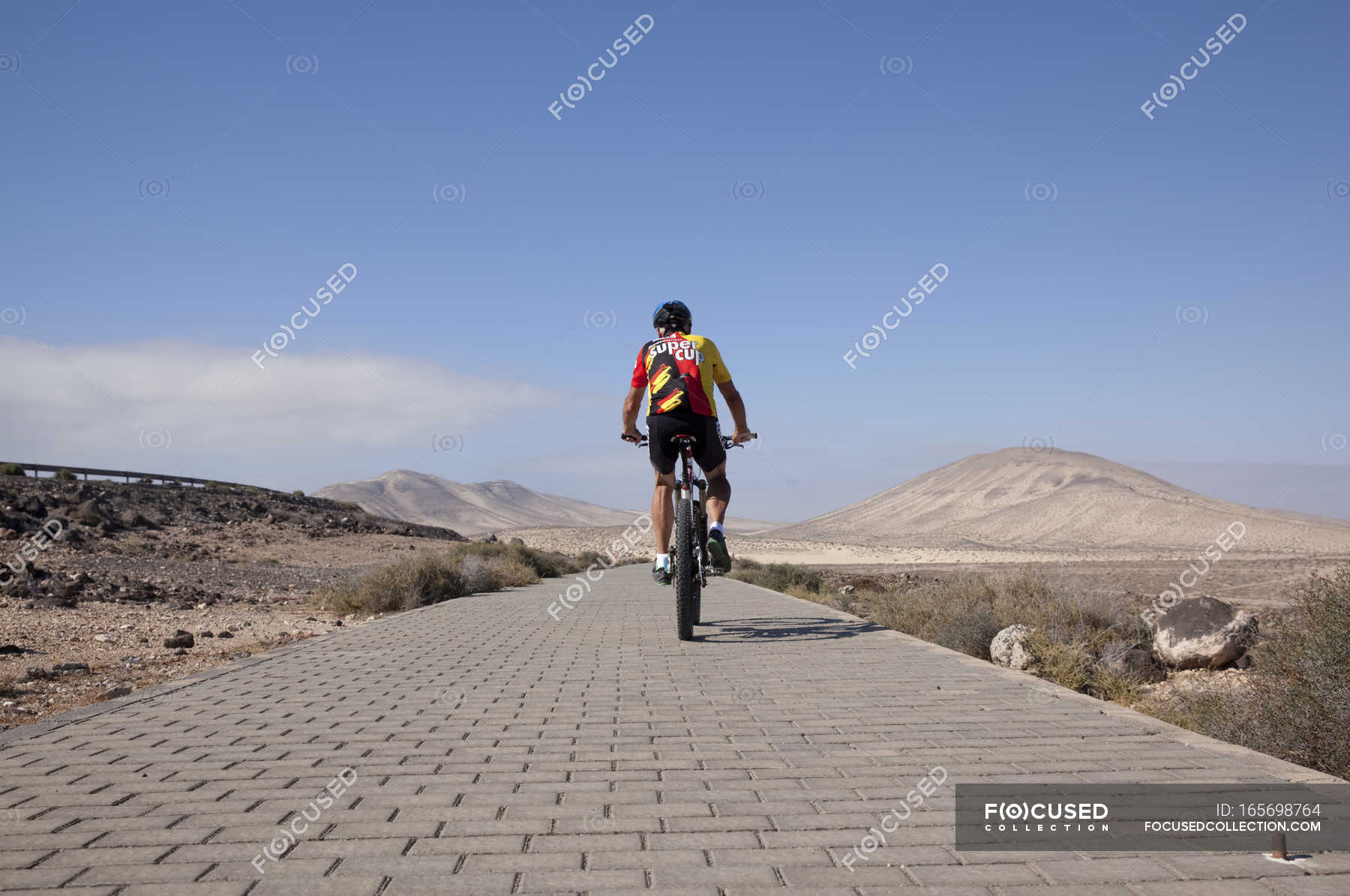 riding a mountain bike on pavement