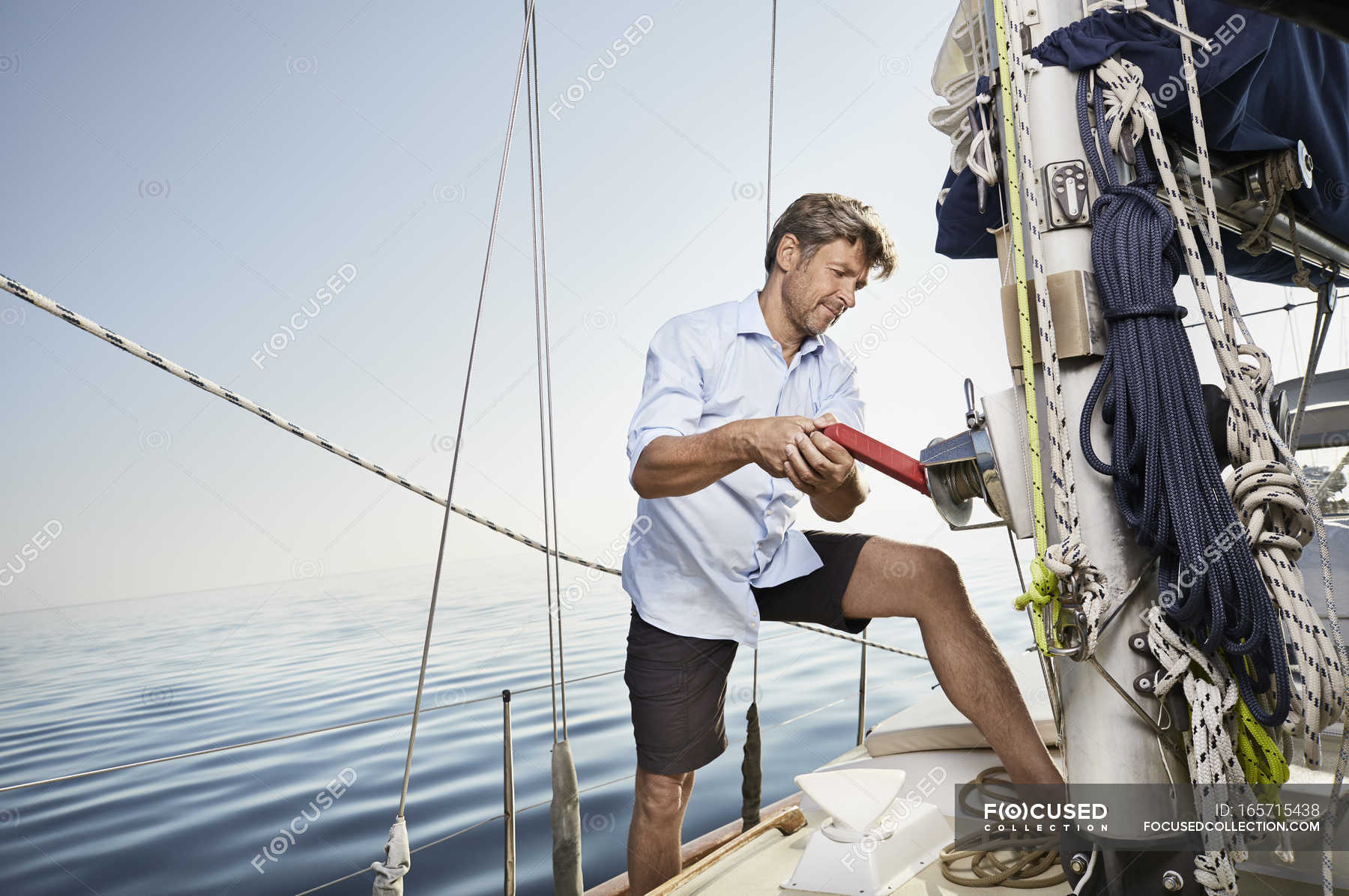 Man Pulling Lever On Sailing Boat Sea Working Stock Photo 165715438