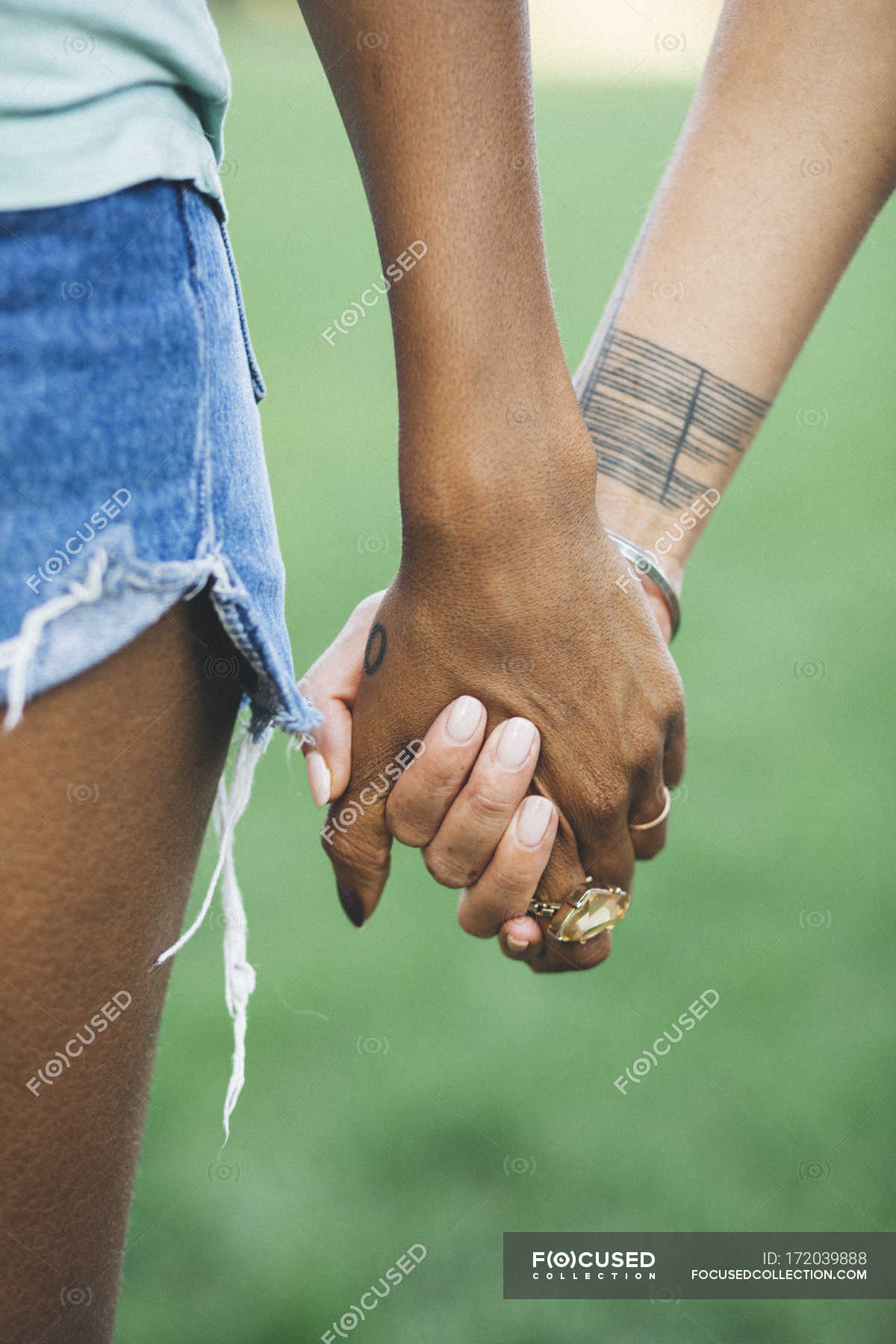 Close-up of Two women holding hands in a park — selective focus