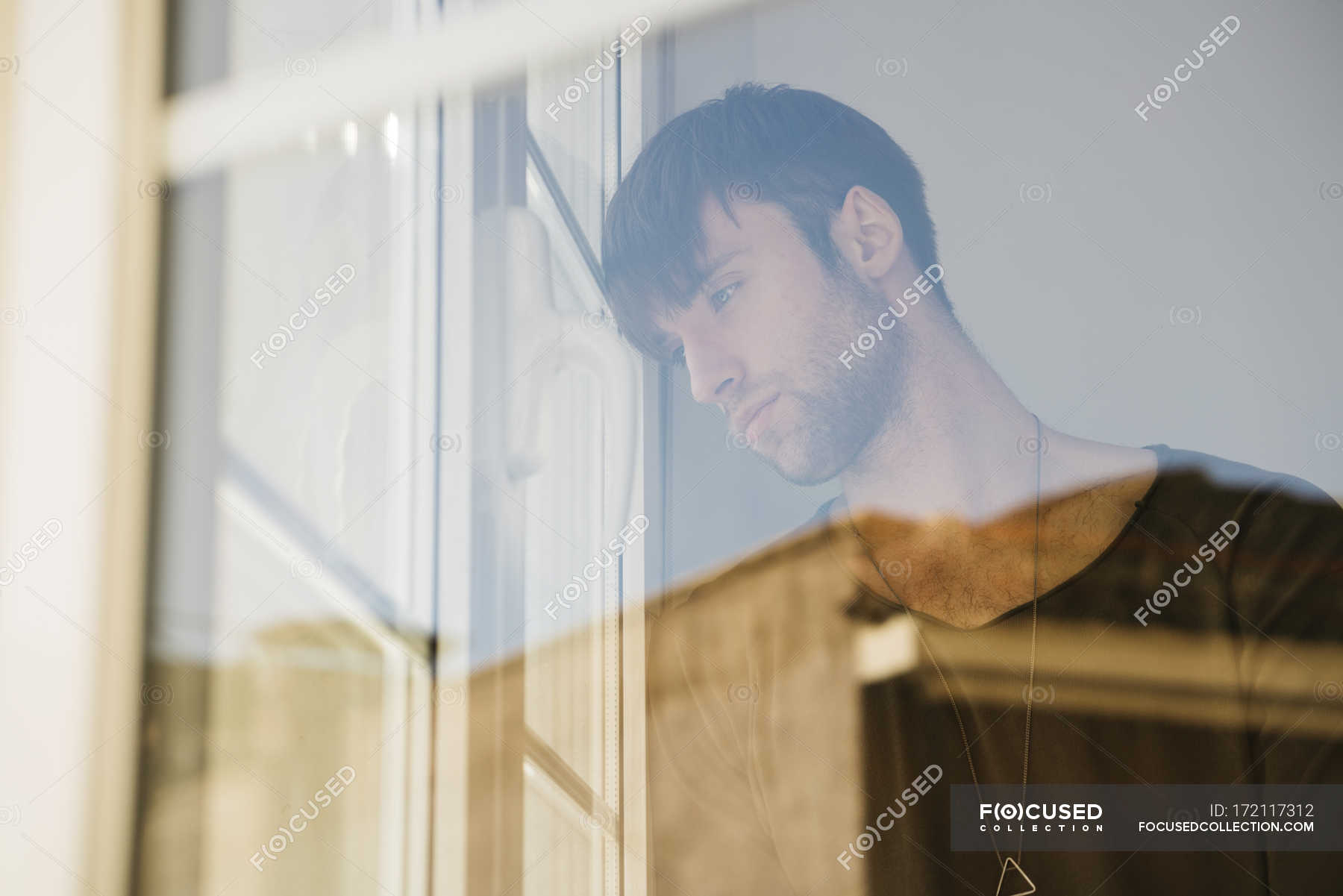 man looking through a window