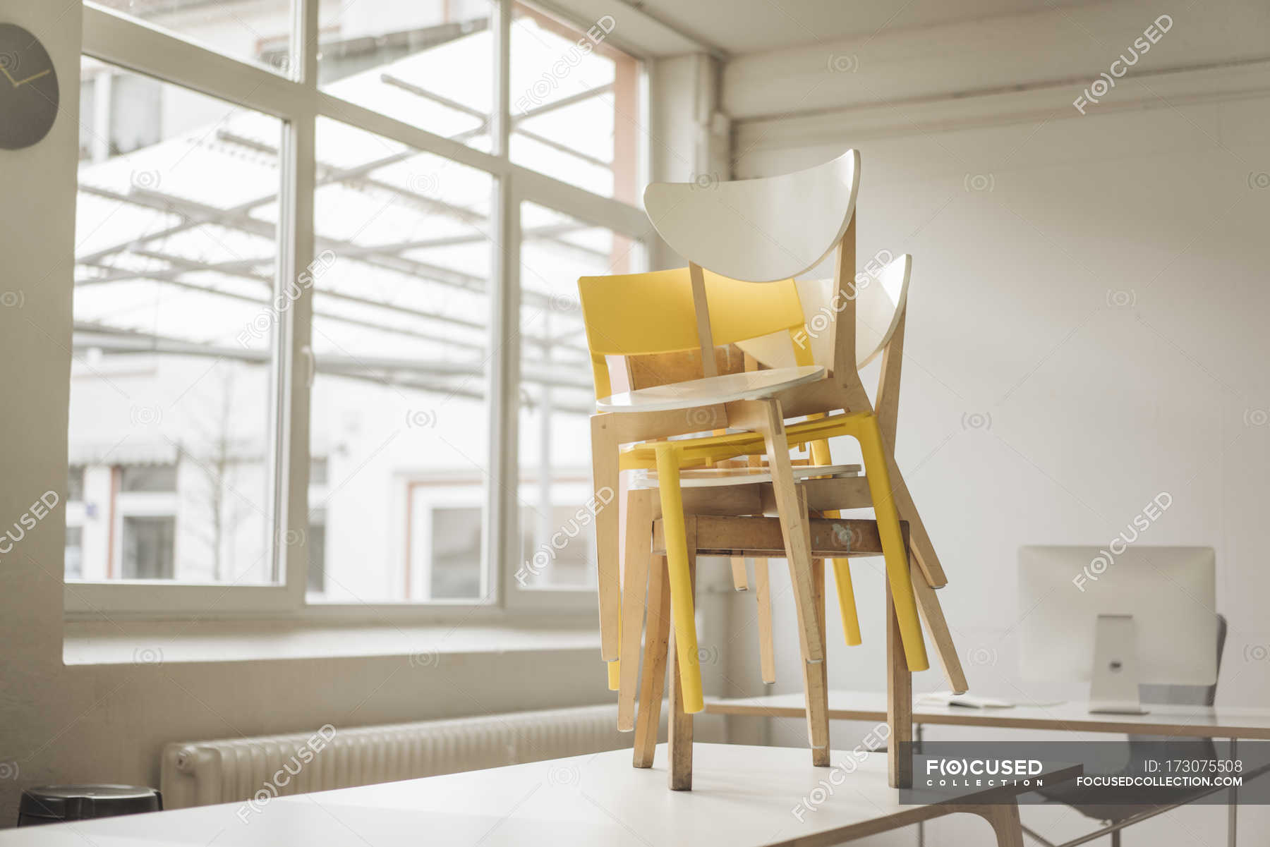 Daytime View Of Chairs Pile Placed On Table Color Image Office