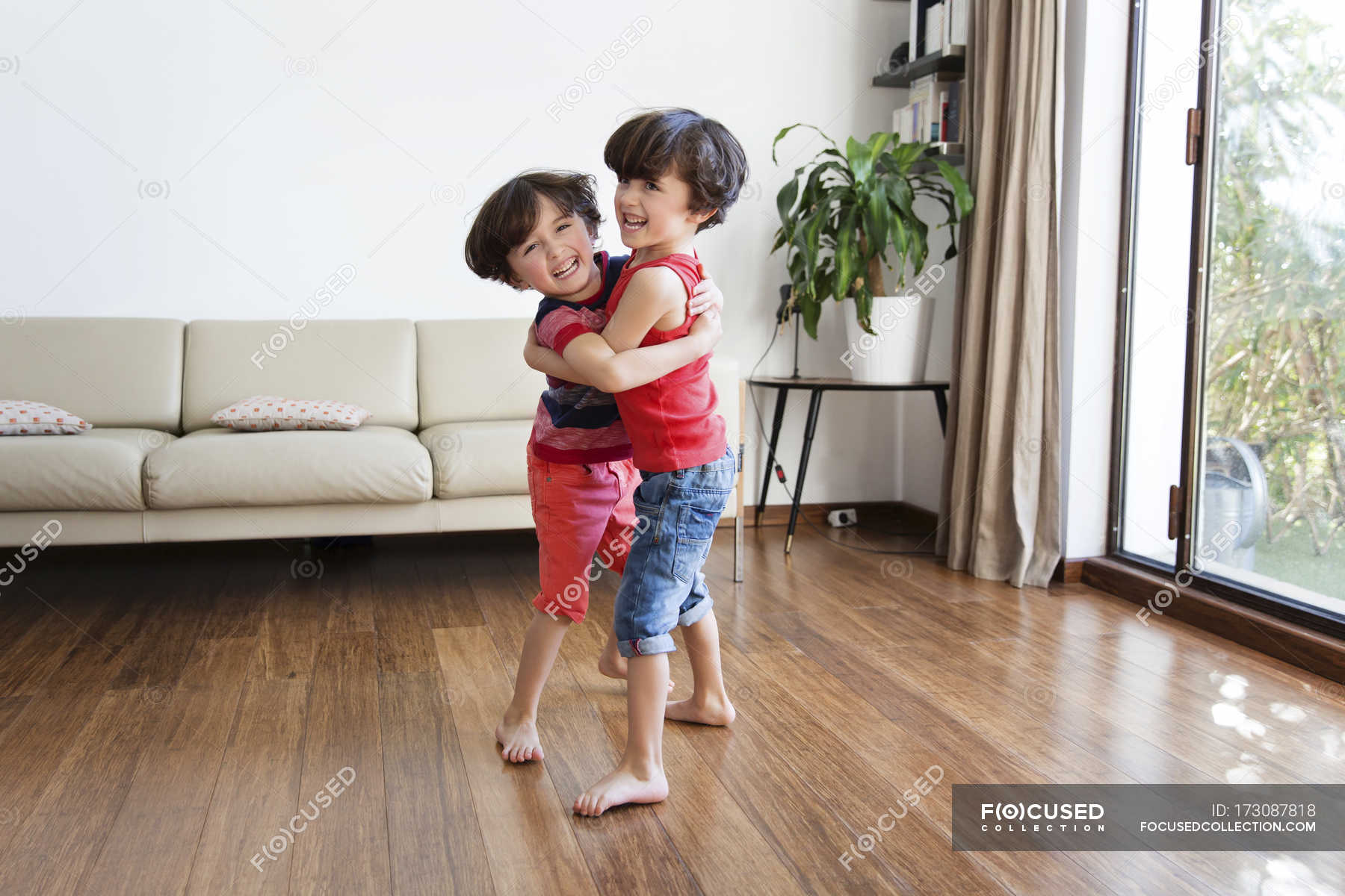 Twin Brothers Playfighting Brown Hair Looking At Camera Stock