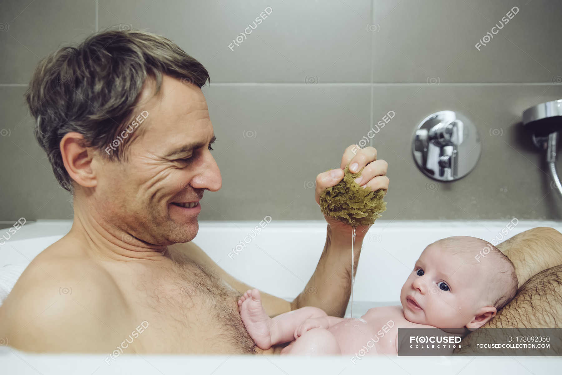 Father And Baby Taking A Bath With A Natural Sponge Together Cute Stock Photo 173092050