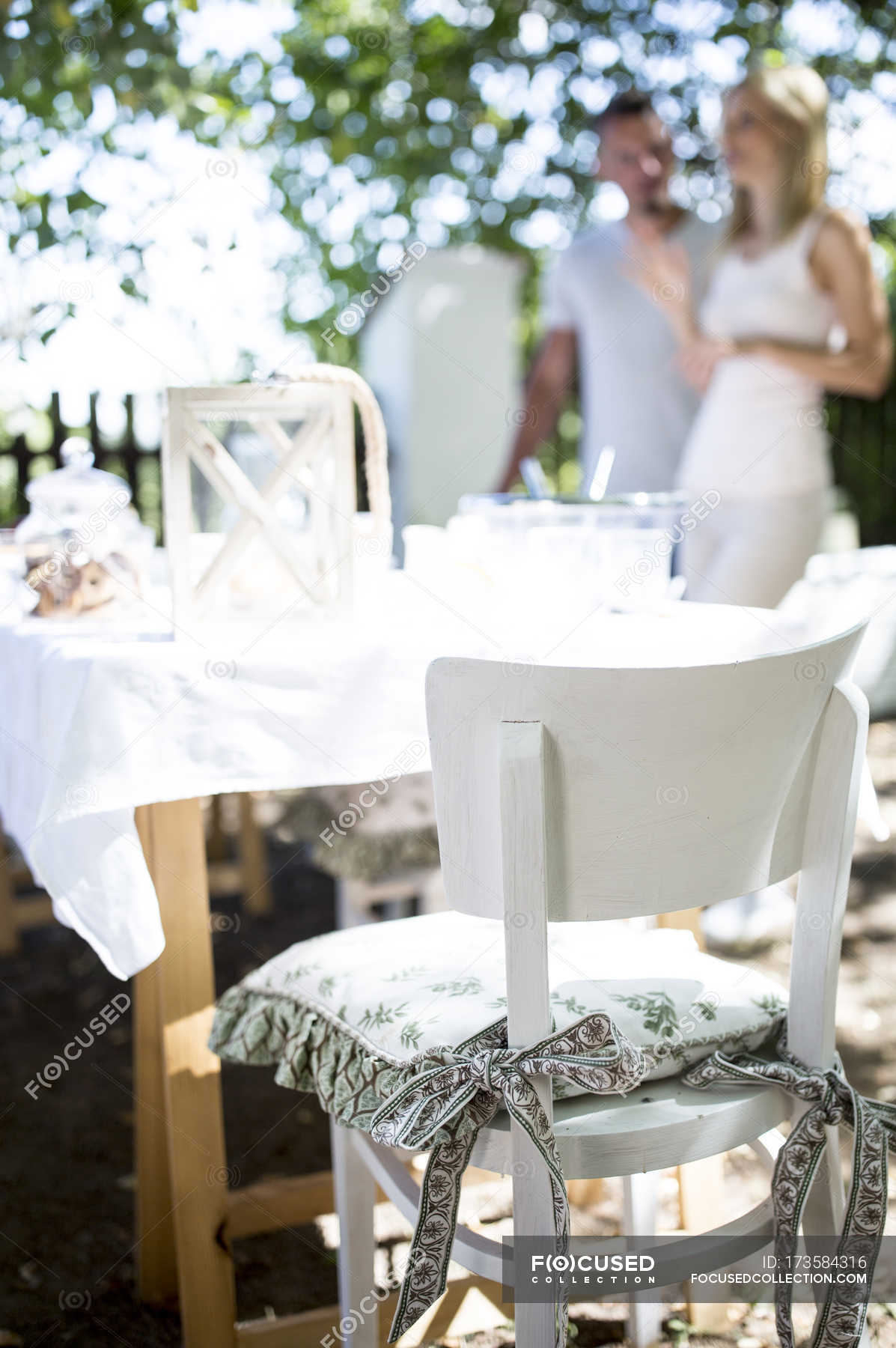 Garden chair with cushion and couple on background — bow, Adults - Stock  Photo | #173584316