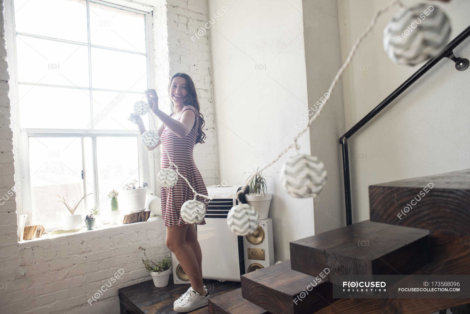 Young Woman Decorating Loft With Fairylights Stairs Content Stock Photo 173588096