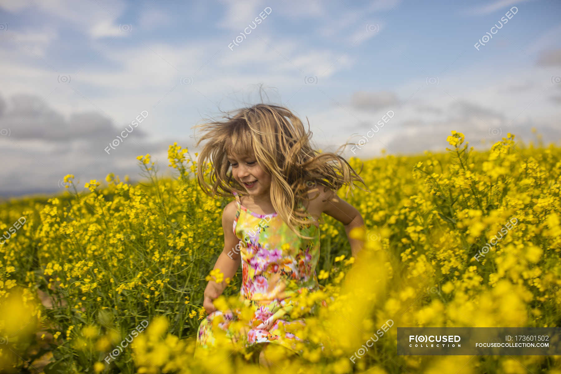 little girl running in field