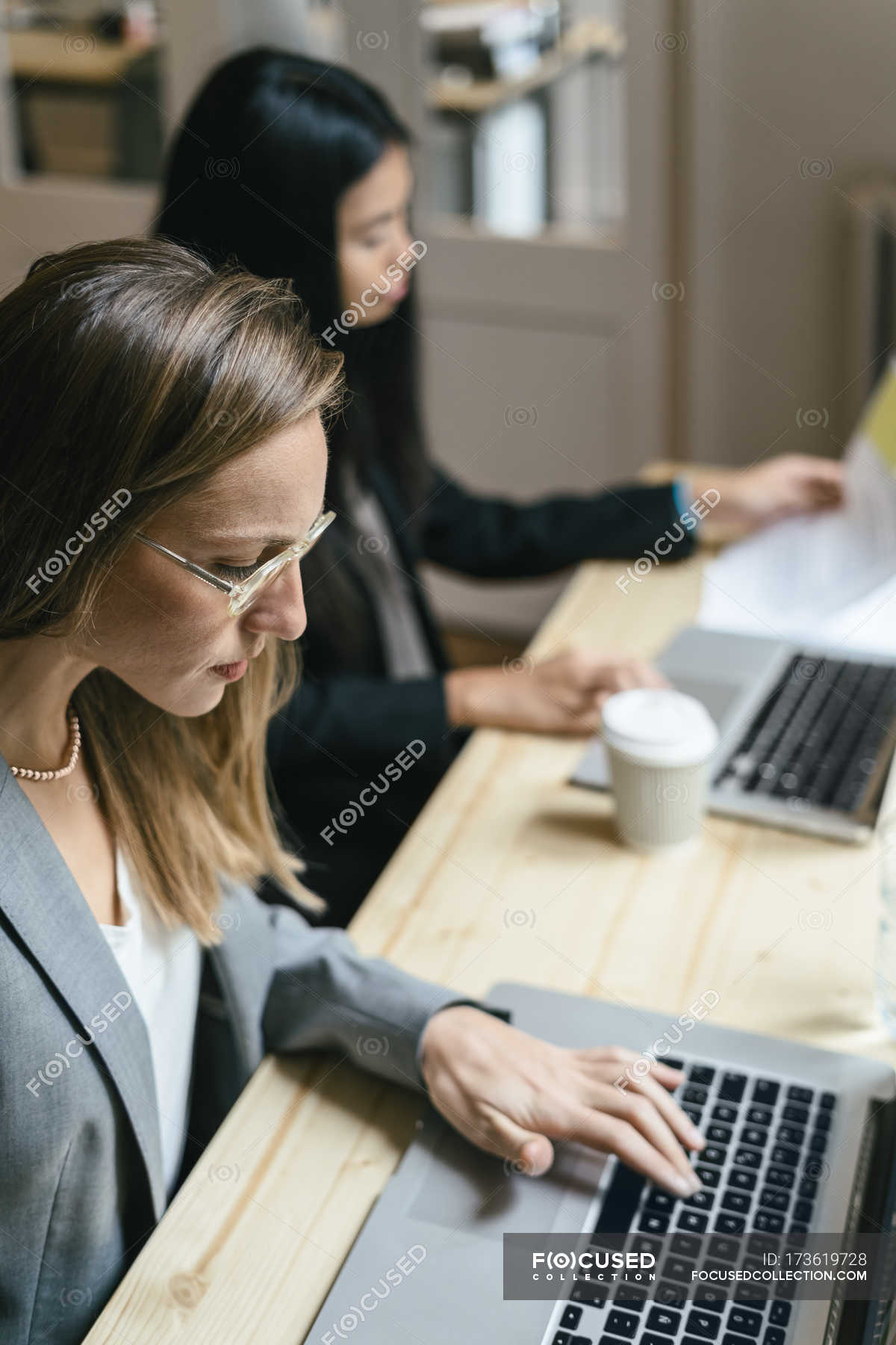 two-business-women-working-together-in-office-wireless-indoors